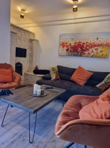 a living room with a couch and a coffee table at P10 Nyaraló in Magyarhertelend