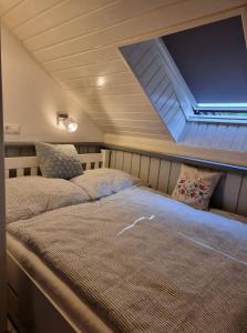 a bedroom with two beds and a large window at P10 Nyaraló in Magyarhertelend