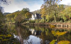 a house on the bank of a river at The Courthouse in Betws-y-coed