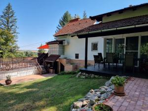 a house with a porch and a patio at P10 Nyaraló in Magyarhertelend