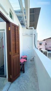 a room with a door and a bench on a balcony at 24 Kimberley in George Town