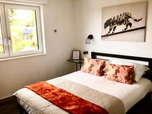 a bedroom with a bed and a window at Bed@BroadOak in Sturminster Newton