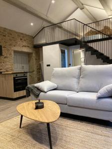 a living room with a couch and a table at Casa María da Retratista in Muxia