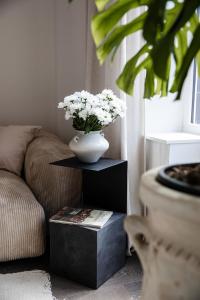 a vase of flowers on a table in a living room at Villa Ostinato in Ostend