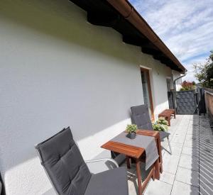 eine Terrasse mit 2 Stühlen, einem Tisch und Stühlen in der Unterkunft Ferienhaus Schwangau in Schwangau