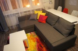 a couch with colorful pillows on it in a living room at Apartmany Ostrava in Ostrava