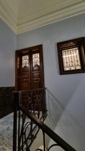 a room with a staircase and a door and windows at La Renaissance in Catania