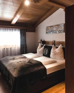 a bedroom with a large bed and a window at Landhaus Andrea Saalbach in Saalbach Hinterglemm