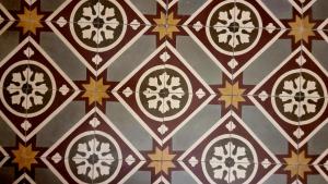 a close up of a tile pattern on a wall at La Renaissance in Catania