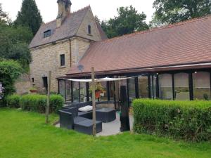 an old building with a pavilion in front of it at South Lodge House in Dormans Land