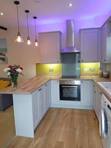 a kitchen with white cabinets and a purple ceiling at Catherine Street Apartments in Salisbury