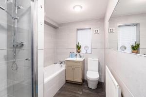 a white bathroom with a shower and a toilet at Boulevard View in Doncaster