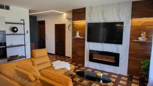 a living room with a couch and a fireplace at I Due Grifoni Luxury Apartment & Spa in Taormina