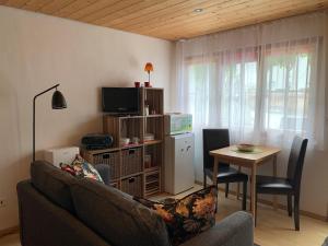 a living room with a couch and a table at Chasa Bazzi in Scuol