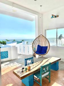 a room with a swing and a table and chairs at IRINI Boutique Homestay Mui Ne in Mui Ne