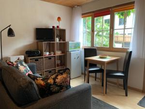 a living room with a couch and a table at Chasa Bazzi in Scuol