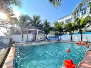 a swimming pool with a person in the water at IRINI Boutique Homestay Mui Ne in Mui Ne