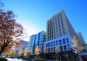 a tall building on a city street with trees at HOTEL MYSTAYS PREMIER Kanazawa in Kanazawa +37 photos