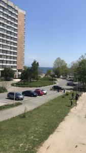 a street with cars parked in a parking lot at Apartament Langa Plaja Diana in Mangalia