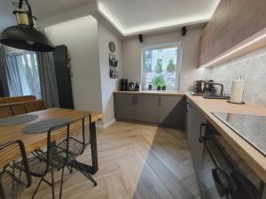 a kitchen with a table and a dining room at Apartament Wiślańskie Skije in Wisła