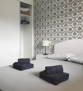 a bedroom with a bed with two pillows on it at New apartment in San Juan Playa, Alicante in Alicante