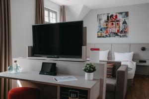 a living room with a flat screen tv on a wall at Maximilian in Speyer