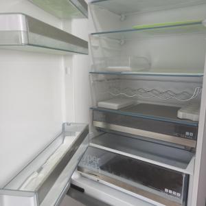 an empty refrigerator with its door open at Apartment 28 in Stadthagen