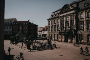 a group of people riding bikes on a city street at Maximilian Studios in Speyer