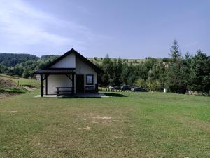 a small building in the middle of a field at Domek na Horbie in Bukowiec