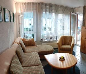a living room with a couch and two chairs and a table at BUPA06107-FeWo-Passat-soess in Burg auf Fehmarn +1 photo
