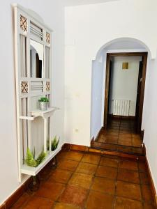 a hallway with white walls and a wooden floor at Villa ALJARAL, Espectacular,piscina,chimenea, climatización, wifi in Córdoba