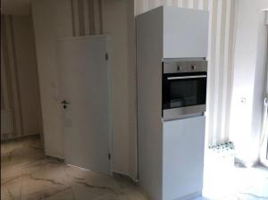 a kitchen with a white refrigerator and an oven at Ferienwohnung Zollverein in Essen