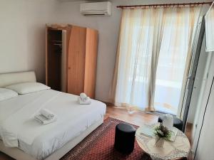 a bedroom with a bed and a large window at Sobe Centar Baška Voda in Baška Voda