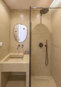 a bathroom with a shower and a sink at KLIMA BAY Beachfront Boutique Houses in Klima