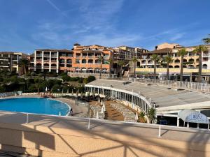 a view of a resort with a swimming pool and buildings at Village Cap Esterel duplex vue mer centre in Agay - Saint Raphael