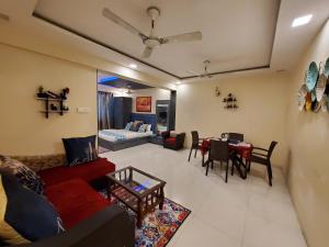 a living room with a couch and a table at Hotel Mari Aai Residency in Navi Mumbai