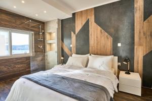a bedroom with a large bed with a wooden wall at Luxury House with Pool-Hosted by Sweetstay in St Paul's Bay