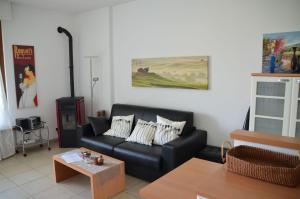 a living room with a black couch and a table at Ferienwohnung-Casa-Uta-Gardasee-Limone-Tremosine in Tremosine Sul Garda