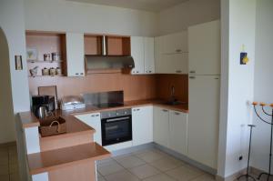 a kitchen with white cabinets and a stove top oven at Ferienwohnung-Casa-Uta-Gardasee-Limone-Tremosine in Tremosine Sul Garda