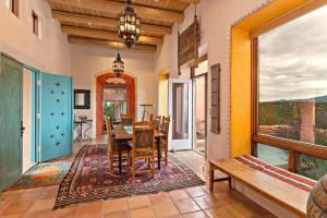 a dining room with a table and chairs and a window at 103 B Estrellas de Tano in Santa Fe