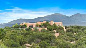 a building in the middle of a forest of trees at 103 B Estrellas de Tano in Santa Fe