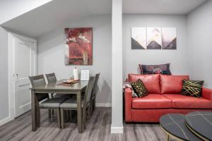 ein Wohnzimmer mit einem roten Sofa und einem Tisch in der Unterkunft Modern & Private 1-Bedroom Apartment in Windsor