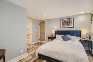 a bedroom with a bed with a blue headboard at 5602 S Spotswood St in Littleton