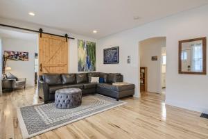 a living room with a leather couch and a table at 5602 S Spotswood St in Littleton