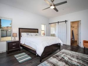 a bedroom with a bed and a ceiling fan at THREE TREE VILLA w/ EV Charging in Yucca Valley