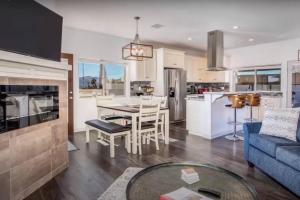 a kitchen and living room with a couch and a table at THREE TREE VILLA w/ EV Charging in Yucca Valley