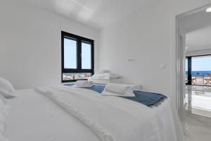 ein weißes Schlafzimmer mit einem Bett und Meerblick in der Unterkunft Apartment Nizza in Makarska