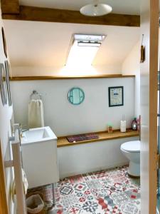 a bathroom with a sink and a toilet at La Ville de Mainguy in Josselin