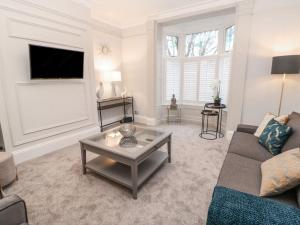 a living room with a couch and a table at 16 Seafield Terrace in South Shields