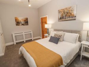 a bedroom with a bed and two paintings on the wall at 16 Seafield Terrace in South Shields